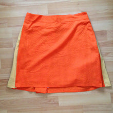 Load image into Gallery viewer, Back view of orange check wrap skirt with yellow contrast pleats.

