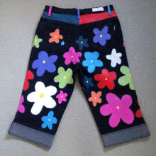 Load image into Gallery viewer, black denim 3/4 length jeans with multicoloured 60s style flowers. yokes and belt loops are painted in bright colours
