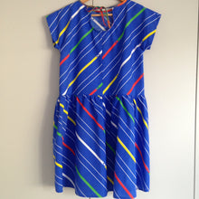 Load image into Gallery viewer, Back view of blue dress with tie. The fabric has diagonal stripes in white, yellow, green and red.
