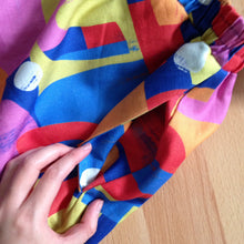 Load image into Gallery viewer, Close up of side seam pocket on colourful, patterned skirt.
