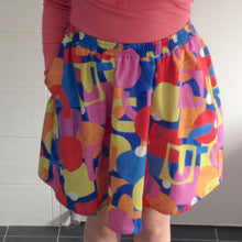 Load image into Gallery viewer, Try on of multicoloured and geometric patterned skirt.

