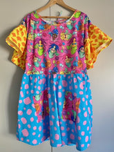 Load image into Gallery viewer, Dress with pink mermaid print bodice and pockets, yellow and orange sleeves and blue and pink skirt.
