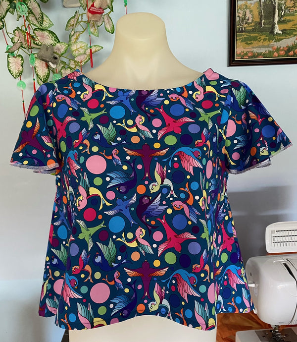 navy short sleeve top with illustrations of multicoloured birds and spots