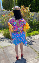 Load image into Gallery viewer, Dress with pink mermaid print bodice and pockets, yellow and orange sleeves and blue and pink skirt. Worn with denim rainbow belt.
